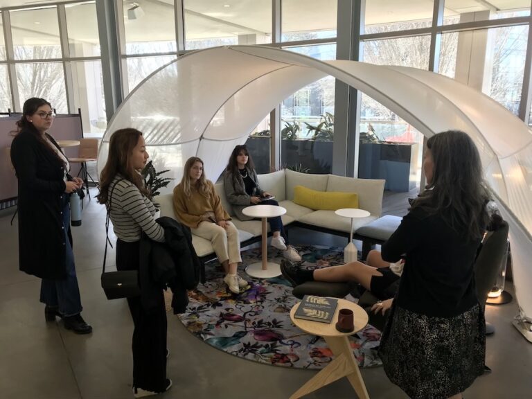 Students explore a modern office setting with interesting furniture