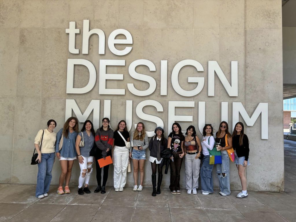 a group of people posing in front of the design museum