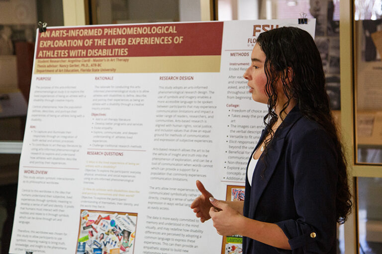 A student presenting her poster
