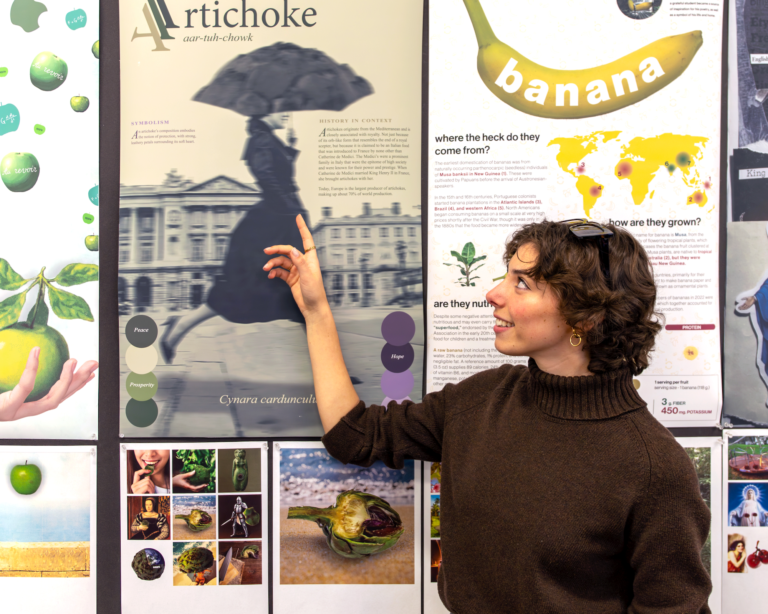 A young woman points at a poster.